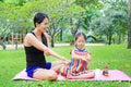 Mother appying body lotion for daughter`s in the summer park Royalty Free Stock Photo