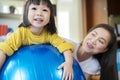 A mother, Asian daughters, they are with a big wind ball