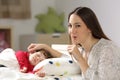 Mother asking for silence with her toddler sleeping