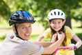 Mother attaching her daughters cycling helmet