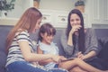 Mother, Aunt and kid having time together lerning with using tablet at home