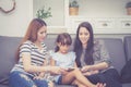 Mother, Aunt and kid having time together lerning with using tablet at home with relax and happy on couch