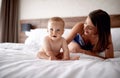 Mother and baby in bed. Young mom playing with her son. Child an Royalty Free Stock Photo