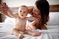 Mother and baby in bed. Young mom playing with her son. Child an Royalty Free Stock Photo
