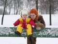 Mother with baby on bench. winter Royalty Free Stock Photo