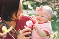 Mother and baby with blooming pink magnolia flower Royalty Free Stock Photo