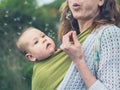 Mother with baby blowing dandelion Royalty Free Stock Photo