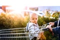 Mother with baby boy going shopping in the car park. Royalty Free Stock Photo