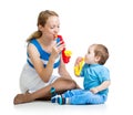 Mother and baby boy having fun with musical toys Royalty Free Stock Photo