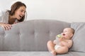 Mother and baby boy are playing on couch Royalty Free Stock Photo
