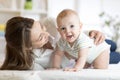 Mother and baby boy playing in sunny bedroom. Parent and little kid relaxing at home. Family having fun together. Royalty Free Stock Photo