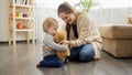 Mother and baby boy playing with teddy bear Royalty Free Stock Photo