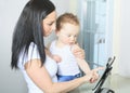 Mother and baby boy using digital tablet in Royalty Free Stock Photo