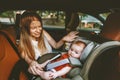 Mother and baby in car child sitting in safety seat Royalty Free Stock Photo