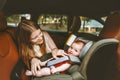 Mother and baby in car family lifestyle Kid sitting in safety car seat Royalty Free Stock Photo