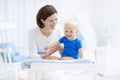 Mother and baby on changing table Royalty Free Stock Photo