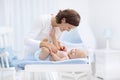 Mother and baby on changing table Royalty Free Stock Photo