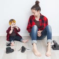 Mother and baby in checkered shirts and jeans