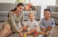 Mother, baby and child on carpet for education, learning and teaching in their living room home with happy portrait Royalty Free Stock Photo