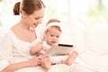 Mother and baby child with tablet computer on the couch at home Royalty Free Stock Photo