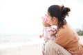 Mother and baby daughter enjoying on the beach. Beautiful family holiday summertime vacation. Royalty Free Stock Photo