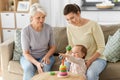 Mother, baby daughter and granny playing at home Royalty Free Stock Photo