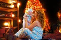 Mother and baby daughter having fun, playing together near Christmas tree in decorated living room Royalty Free Stock Photo