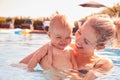 Mother With Baby Daughter Having Fun On Summer Vacation Splashing In Outdoor Swimming Pool Royalty Free Stock Photo