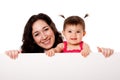 Mother and baby daughter holding white board