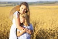 Mother and baby daughter hugging in the wheat field Royalty Free Stock Photo