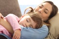 Mother and baby daughter sleeping on couch Royalty Free Stock Photo