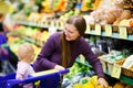 Mother and baby daughter in supermarket Royalty Free Stock Photo