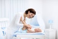 Mother and baby on changing table Royalty Free Stock Photo