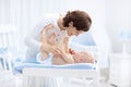 Mother and baby in diaper on changing table