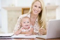 Mother and baby in dining room with laptop Royalty Free Stock Photo