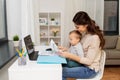 Mother with baby and documents working at home Royalty Free Stock Photo