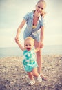 Mother and baby doing first steps