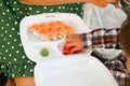 Mother with baby eat sushi on the street on the street Royalty Free Stock Photo