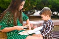 Mother with baby eat sushi on the street on the street Royalty Free Stock Photo