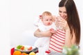 Mother and Baby eating at Home. Happy Smiling Family portrait Royalty Free Stock Photo