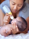 Mother, baby and feeding milk from bottle for nutrition, health and wellness. Formula, newborn and mom feed child for Royalty Free Stock Photo