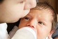 Mother and baby, mother feeds the baby, baby boy drinking a milk