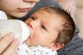 Mother and baby, mother feeds the baby, baby boy drinking a milk