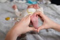 Mother Baby Feet In Heart Shaped Hand in newborn baby Infant Care Concept Royalty Free Stock Photo