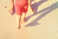 Mother and baby feet walking on sand beach Royalty Free Stock Photo