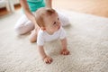 Mother with baby on floor at home