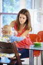 Mother, baby and food in feeding chair for nutrition, growth and development at table in kitchen of home. Woman, infant