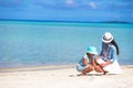 Mother and baby girl drawing on sandy beach Royalty Free Stock Photo