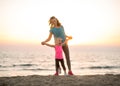 Mother and baby girl having fun time on beach Royalty Free Stock Photo