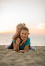 Mother and baby girl laying on beach Royalty Free Stock Photo